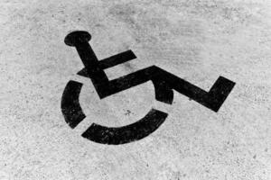 Handicapped sign on the asphalt. Black and white. photo