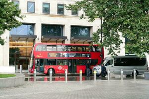 Gorgeous Low Angle view of Bus Service and British Traffic at Central London City of England UK. Image Captured on August 2nd, 2023 During Cloudy and Rainy Day. photo
