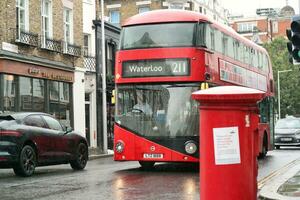 Gorgeous Low Angle view of Bus Service and British Traffic at Central London City of England UK. Image Captured on August 2nd, 2023 During Cloudy and Rainy Day. photo