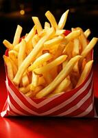 Fries inside a red bag on red background photo
