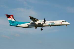 Luxair Bombardier DHC-8 Q400 LX-LQD passenger plane landing at Hamburg Airport photo