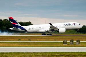 LATAM Qatar Airways Airbus A350-900 A7-AMC passenger plane arrival and landing at Munich Airport photo