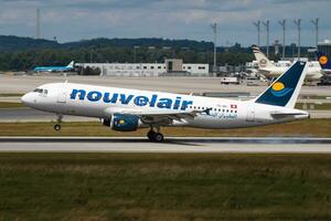 Nouvelair Airbus A320 TS-INH passenger plane arrival and landing at Munich Airport photo