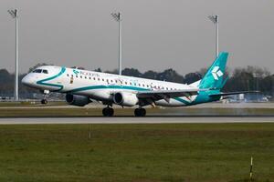 Air Dolomiti passenger plane at airport. Schedule flight travel. Aviation and aircraft. Air transport. Global international transportation. Fly and flying. photo