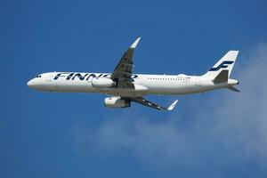 Finnair passenger plane at airport. Schedule flight travel. Aviation and aircraft. Air transport. Global international transportation. Fly and flying. photo