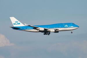 KLM Royal Dutch Airlines Boeing 747-400 Jumbojet PH-BFU passenger plane arrival and landing at Amsterdam Schipol Airport photo