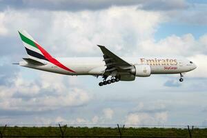 Emirates SkyCargo Boeing 777-200 A6-EFE cargo plane arrival and landing at Amsterdam Schipol Airport photo