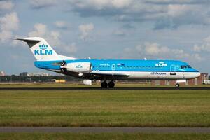 KLM Fokker 70 PH-WXC passenger plane landing at Amsterdam Schipol Airport photo