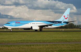 Arkefly TUI Boeing 737-800 PH-TFB passenger plane departure at Amsterdam Schipol Airport photo