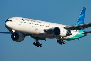 Garuda Indonesia passenger plane at airport. Schedule flight travel. Aviation and aircraft. Air transport. Global international transportation. Fly and flying. photo