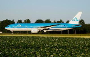 KLM Royal Dutch Airlines Boeing 777-200 PH-BQD passenger plane taxiing at Amsterdam Schipol Airport photo