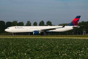 Delta Airlines Airbus A330-300 N811NW passenger plane arrival and landing at Amsterdam Schipol Airport photo