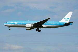 KLM Asia Boeing 777-200 PH-BQI passenger plane arrive and landing at Amsterdam Schipol Airport photo