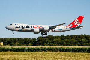 Cargolux special livery Boeing 747-8 Jumbo Jet LX-VCM cargo plane arrival and landing at Luxembourg Findel airport photo