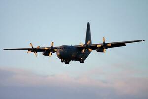 Military transport plane at air base. Air force flight operation. Aviation and aircraft. Air defense. Military industry. Fly and flying. photo