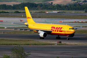 DHL cargo plane at airport. Air freight and shipping. Aviation and aircraft. Transport industry. Global international transportation. Fly and flying. photo