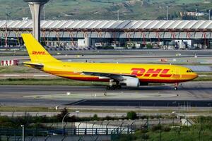 DHL cargo plane at airport. Air freight and shipping. Aviation and aircraft. Transport industry. Global international transportation. Fly and flying. photo