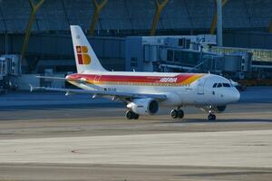 Iberia Airlines passenger plane at airport. Schedule flight travel. Aviation and aircraft. Air transport. Global international transportation. Fly and flying. photo