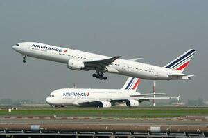 Air France Boeing 777-300ER F-GSQY passenger plane departure and take off at Paris Charles de Gaulle Airport photo