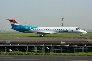 Luxair passenger plane at airport. Schedule air travel. Aviation and aircraft. Air transport. Global international transportation. Fly and flying. photo