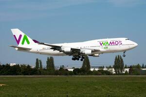 Wamos Air passenger plane at airport. Schedule flight travel. Aviation and aircraft. Air transport. Global international transportation. Fly and flying. photo