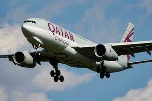 Qatar Airways cargo plane at airport. Air freight and shipping. Aviation and aircraft. Transport industry. Global international transportation. Fly and flying. photo