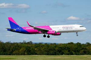 Wizz Air passenger plane at airport. Schedule flight travel. Aviation and aircraft. Air transport. Global international transportation. Fly and flying. photo