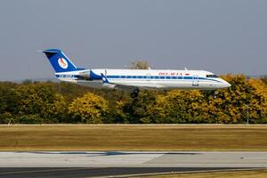 Belavia Bombardier CRJ-200 EW-303PJ passenger plane arrival and landing at Budapest Airport photo