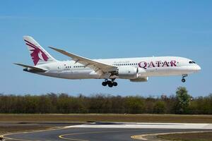 Qatar Airways passenger plane at airport. Schedule flight travel. Aviation and aircraft. Air transport. Global international transportation. Fly and flying. photo