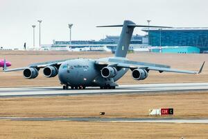 Indian Air Force Boeing C-17A Globemaster III military transport plane and aircraft at Budapest Airport. Evacuation special flight for indian citizens because the Ukraine-Russian war. photo