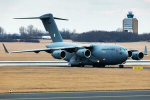 Indian Air Force Boeing C-17A Globemaster III military transport plane and aircraft at Budapest Airport. Evacuation special flight for indian citizens because the Ukraine-Russian war. photo