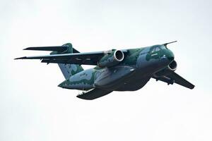 Embraer KC-390 Millennium. Military transport plane at air base. Air force flight operation. Aviation and aircraft. Air lift. Military industry. Fly and flying. photo