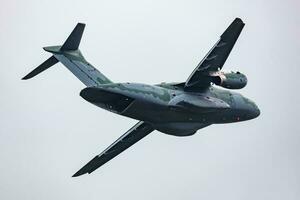 Embraer KC-390 Millennium. Military transport plane at air base. Air force flight operation. Aviation and aircraft. Air lift. Military industry. Fly and flying. photo
