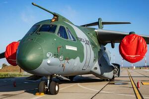 Embraer KC-390 Millennium. Military transport plane at air base. Air force flight operation. Aviation and aircraft. Air lift. Military industry. Fly and flying. photo