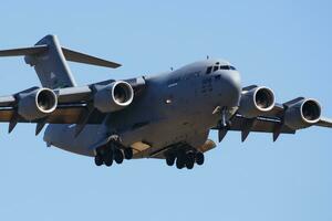 Military transport plane at air base. Air force flight operation. Aviation and aircraft. Air lift. Military industry. Fly and flying. photo