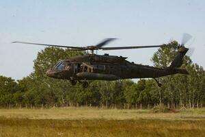 US Army Sikorsky UH-60 Black Hawk military helicopter at air base. Aviation and rotorcraft. Transport and airlift. Fly and flying. photo