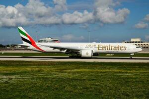 Emirates passenger plane at airport. Schedule flight travel. Aviation and aircraft. Air transport. Global international transportation. Fly and flying. Arrival and landing. photo