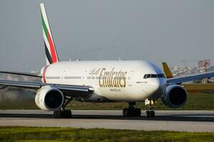 Emirates passenger plane at airport. Schedule flight travel. Aviation and aircraft. Air transport. Global international transportation. Fly and flying. Departure and take off. photo