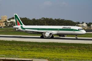 Alitalia passenger plane at airport. Schedule flight travel. Aviation and aircraft. Air transport. Global international transportation. Fly and flying. photo