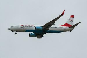 Austrian Airlines passenger plane at airport. Schedule flight travel. Aviation and aircraft. Air transport. Global international transportation. Fly and flying. photo