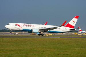 Austrian Airlines passenger plane at airport. Schedule flight travel. Aviation and aircraft. Air transport. Global international transportation. Fly and flying. photo