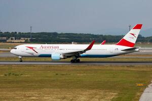 Austrian Airlines passenger plane at airport. Schedule flight travel. Aviation and aircraft. Air transport. Global international transportation. Fly and flying. photo