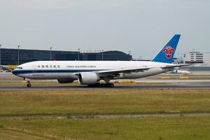 China Southern cargo plane at airport. Air freight and shipping. Aviation and aircraft. Transport industry. Global international transportation. Fly and flying. photo