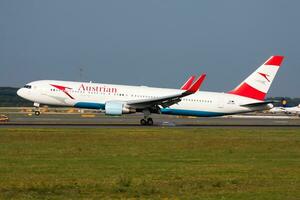 Austrian Airlines passenger plane at airport. Schedule flight travel. Aviation and aircraft. Air transport. Global international transportation. Fly and flying. photo