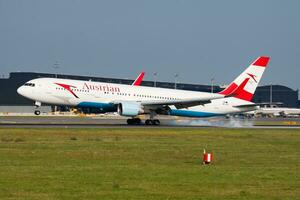 Austrian Airlines passenger plane at airport. Schedule flight travel. Aviation and aircraft. Air transport. Global international transportation. Fly and flying. photo