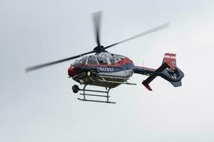 Austrian government police helicopter at airport and airfield. Rotorcraft. General aviation industry. Police utility transportation. Air transport. Fly and flying. photo