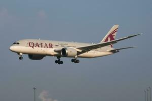 Qatar Airways Boeing 787-8 Dreamliner A7-BCA passenger plane arrival and landing at Vienna Airport photo