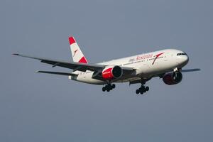 Austrian Airlines Boeing 777-200 OE-LPD passenger plane arrival and landing at Vienna Airport photo