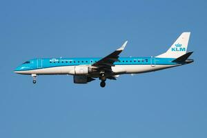 KLM Embraer ERJ-190 PH-EZF passenger plane arrival and landing at Vienna Airport photo