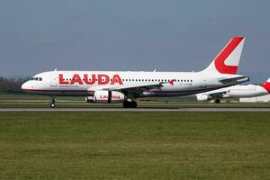 Laudamotion Airbus A320 OE-LOB passenger plane arrival and landing at Vienna International Airport photo